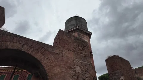 An old brick water tower stands as a relic of early industrial architecture Stock Footage 320957161