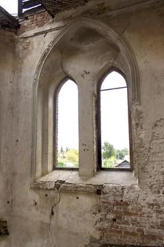 Old brick window openings without glass in the ruins of the old brick Stock Photos