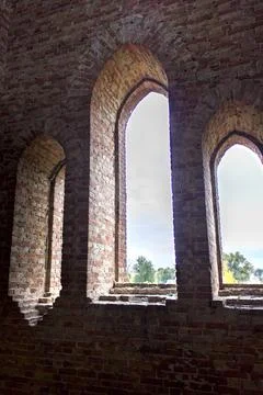 Old brick window openings without glass in the ruins of the old brick Stock Photos