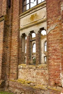Old brick window openings without glass in the ruins of the old brick Stock Photos