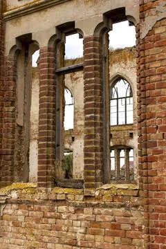 Old brick window openings without glass in the ruins of the old brick Stock Photos