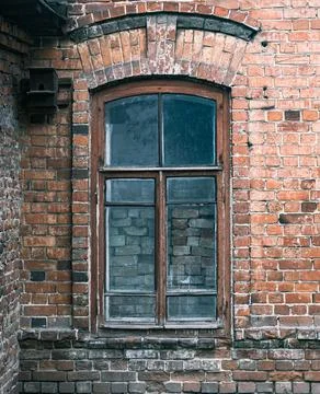 An old bricked up window in old brick house Stock Photos