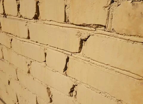 The old bricks of the building are painted yellow Stock Photos