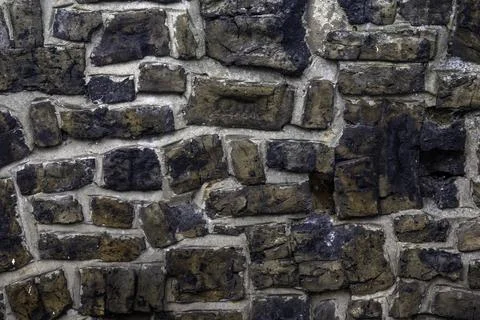 Old bricks in a garden wall for use as a background texture Stock Photos
