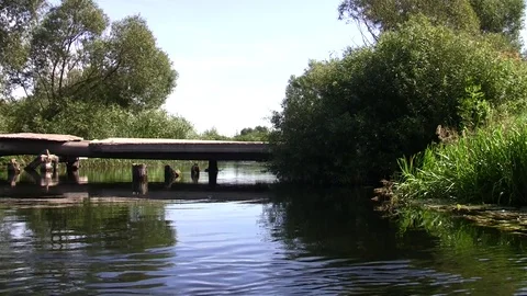 Old bridge across the river with a quiet current Stock Footage 85627274