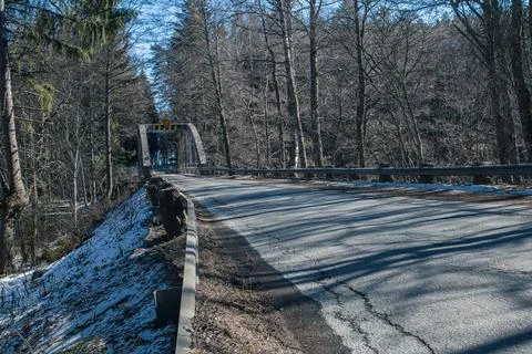 Old bridge across the river Spring landscape in April of a forest river. Snow Stock Photos