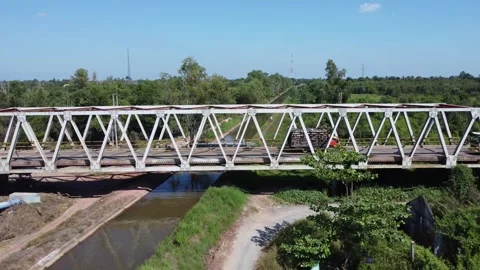 Old bridge crossed by many loaded trucks with a road full of holes Stock Footage 315260201