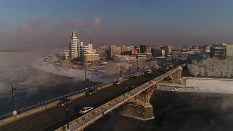 The old bridge over the Angara river. Steam is emitted from the wate Stock-Footage 165611473