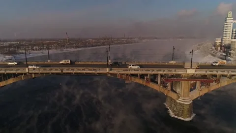 The old bridge over the Angara river. Steam is emitted from the wate Stock Footage 165611482