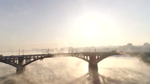 The old bridge over the Angara river. Steam is emitted from the wate Stock-Footage 165611509
