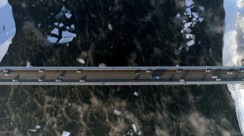 The old bridge over the Angara river. Steam is emitted from the water Stock Photos
