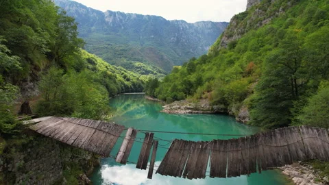 Old bridge over the river in the canyon Stock Footage 167441742