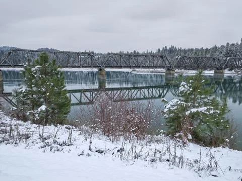 Old bridge over the river in winter. Stock Photos