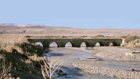 Old bridge on river in remote area Stock Footage 83174463