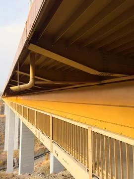 Old bridge side view from below, pedestrian passage under the bridge, water Stock Photos