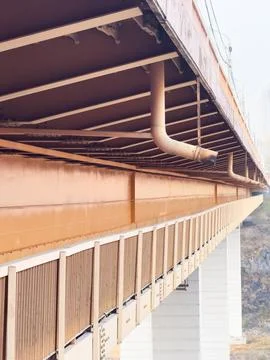 Old bridge side view from below, pedestrian passage under the bridge, water Stock Photos