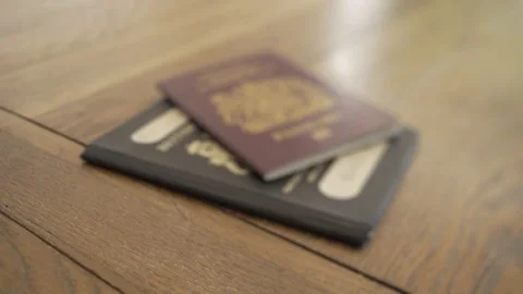 Old British and Current EU Passports come into and then out of focus Stock Footage 111777316