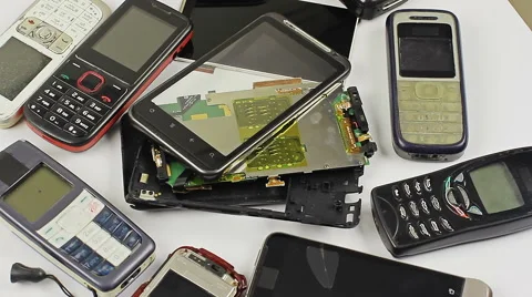 Old, broken and obsolete cellphone close up rotation on white background. Stock Footage 55010118