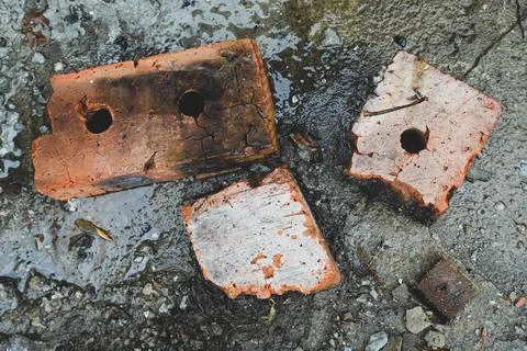 Old broken bricks at the construction site - top view. Industrial background Stock Photos