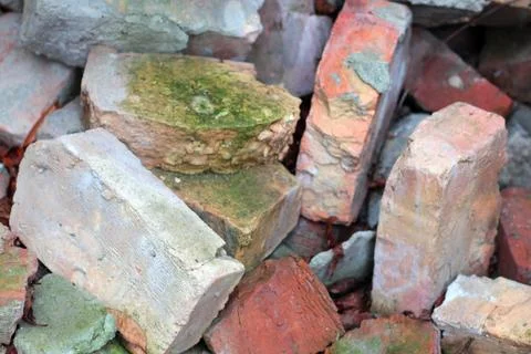 Old broken bricks covered with moss background Stock Photos