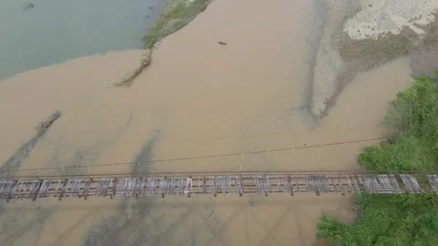 The old broken bridge still hangs over the river Video stock 266225053