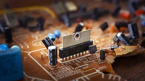 Old broken brown microcircuit close-up, old technology Stock Photos