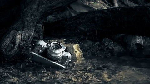 Old broken camera lost on the river bank Stock Footage 76836814