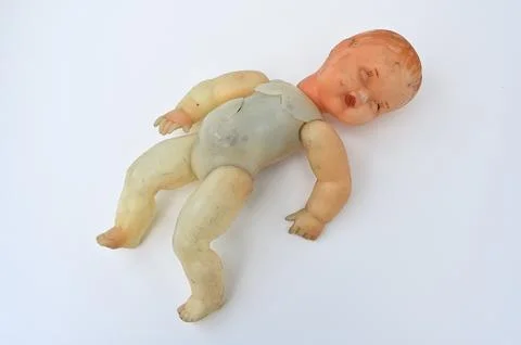 Old broken doll on a white Stock Photos