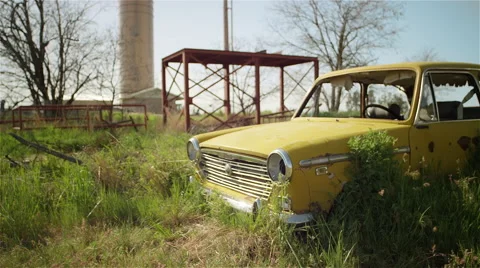 An old broken down car sits abandoned in a field Stock Footage 51895672