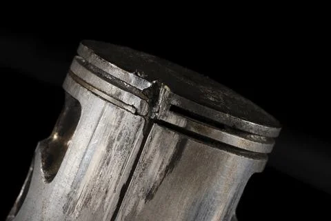 Old Broken Engine Piston Isolated On Black Background Foto stock
