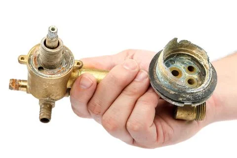 Old broken faucets for the shower in the hand Foto stock