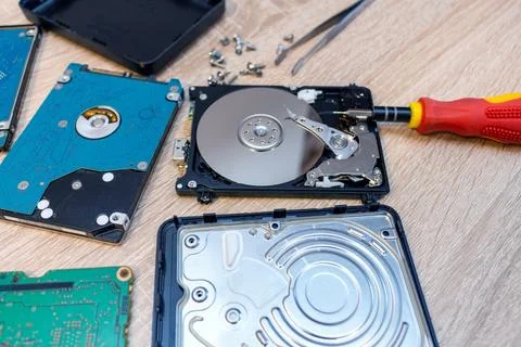 Old broken hard disk drives composition in a repair recovery service concept  Stock Photos