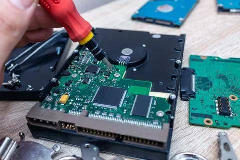 Old broken hard disk drives composition in a repair recovery service concept  Stock Photos