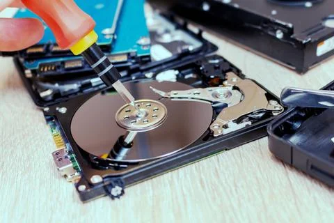 Old broken hard disk drives composition in a repair recovery service concept  Stock Photos