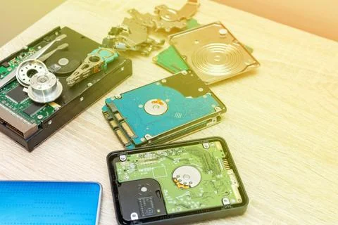 Old broken hard disk drives composition in a repair recovery service concept  Stock Photos