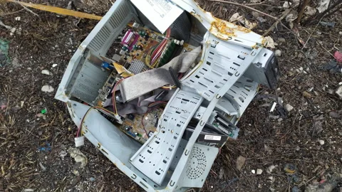 Old broken PC computer on a junkyard - components inside deformed case of Stock Footage 233278003