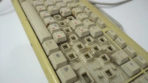 Old broken personal computer keyboard on a white table. Close-up view. 库存影片 144914381