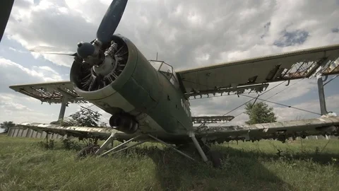 Old, broken plane on a green meadow shooting near Stock-Footage 74373813