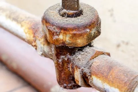 Old broken rusty heating valve on a rusty pipeline of heating battery need to Stock Photos