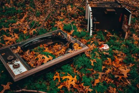 An Old Broken Televison Set in a Patch of Orange Leaves Stock Photos