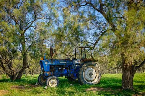 Old broken tractor abandoned in the forest Stock Photos