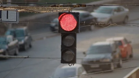 The old broken traffic light hangs on the wire above the road Stockbeeldmateriaal 75004975