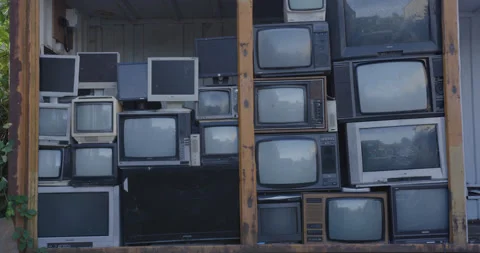 Old broken TV's piled up in dump Stock Footage 136530949