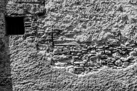An old broken wall on the facade of an old house Stock Photos