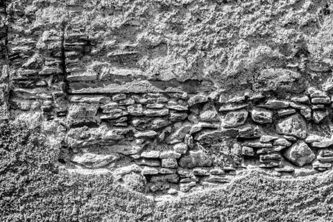 An old broken wall on the facade of an old house Stock Photos
