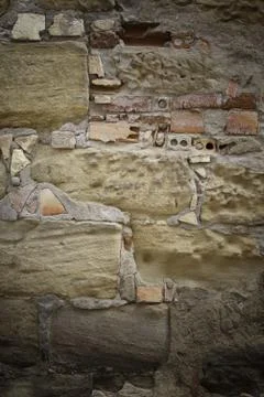 Old broken wall made of mud bricks, textured background detail, neglect and r Stock Photos