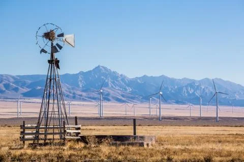 Old broken wind mill in front of big new wind farm in the Mineral Mountains.. Stock Photos