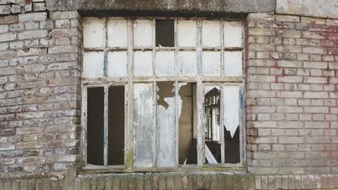 Old broken window on an abandoned old building Stock Photos