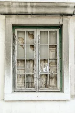 Old, broken window. Boarded up from the inside Stock Photos