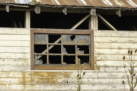 Old broken window on an old building Stock Photos